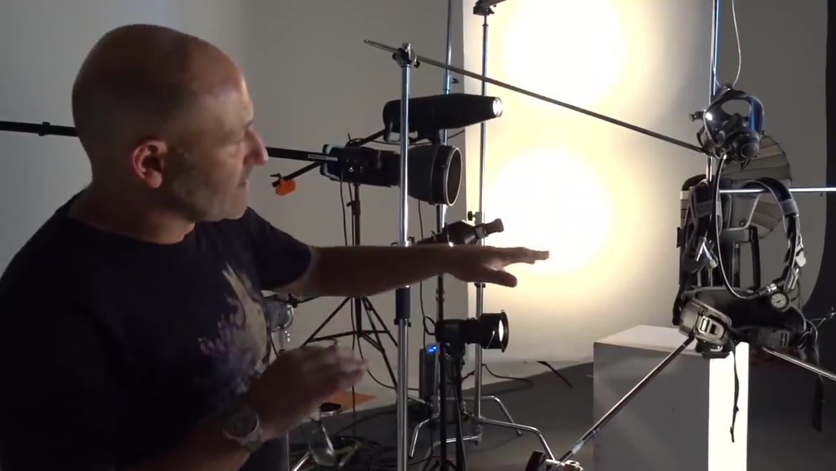 C-stands and grip arms holding lights in precise positions around set