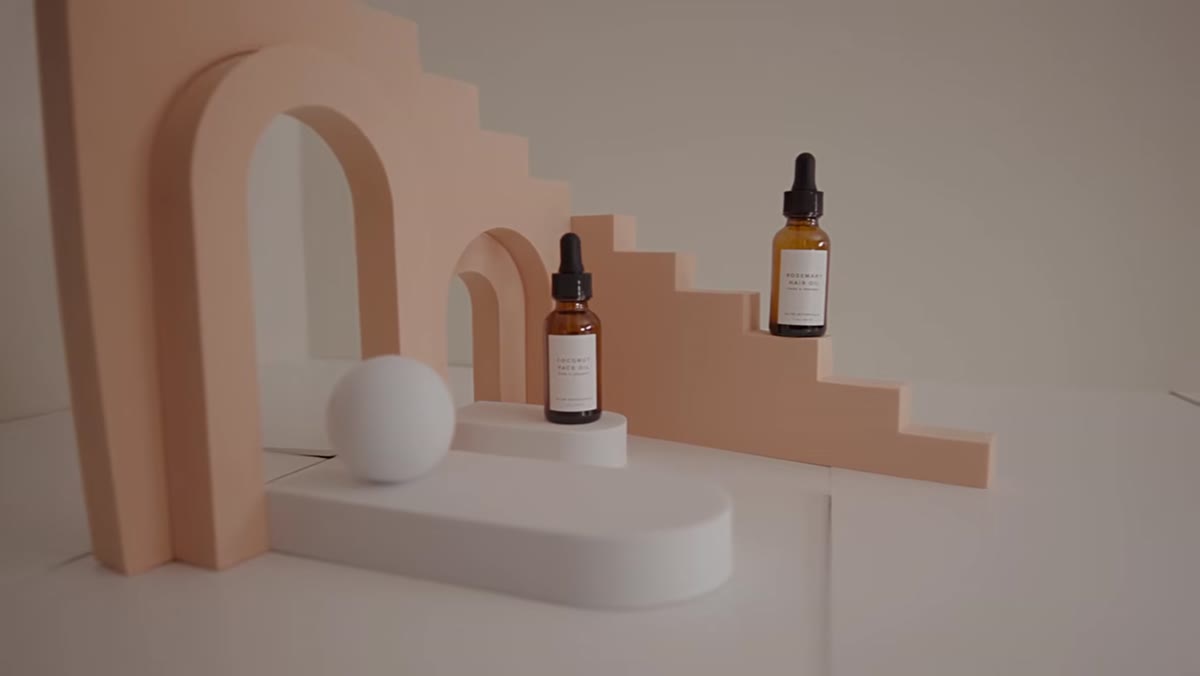 Props in pastel orange, green, and white arranged around product bottles