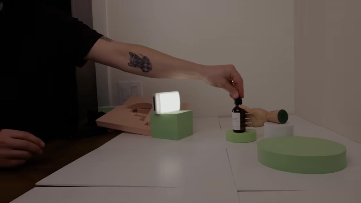 Wooden hand prop introduced next to clean geometric foam props