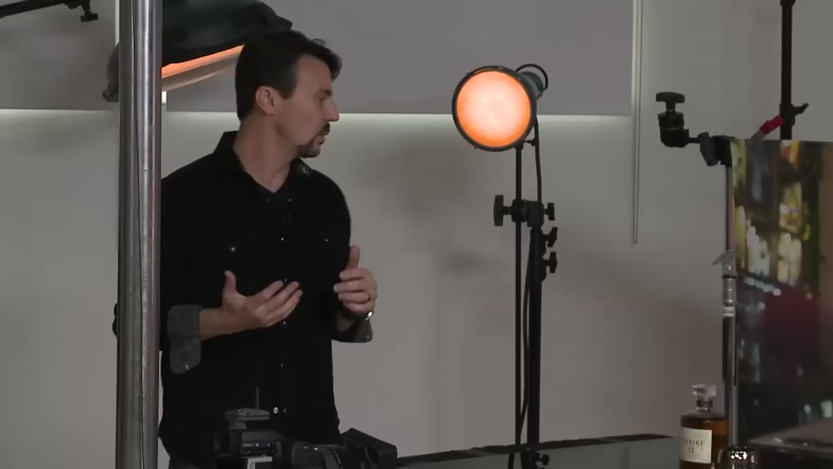 Rob Grimm standing next to multiple strobes explaining light selection