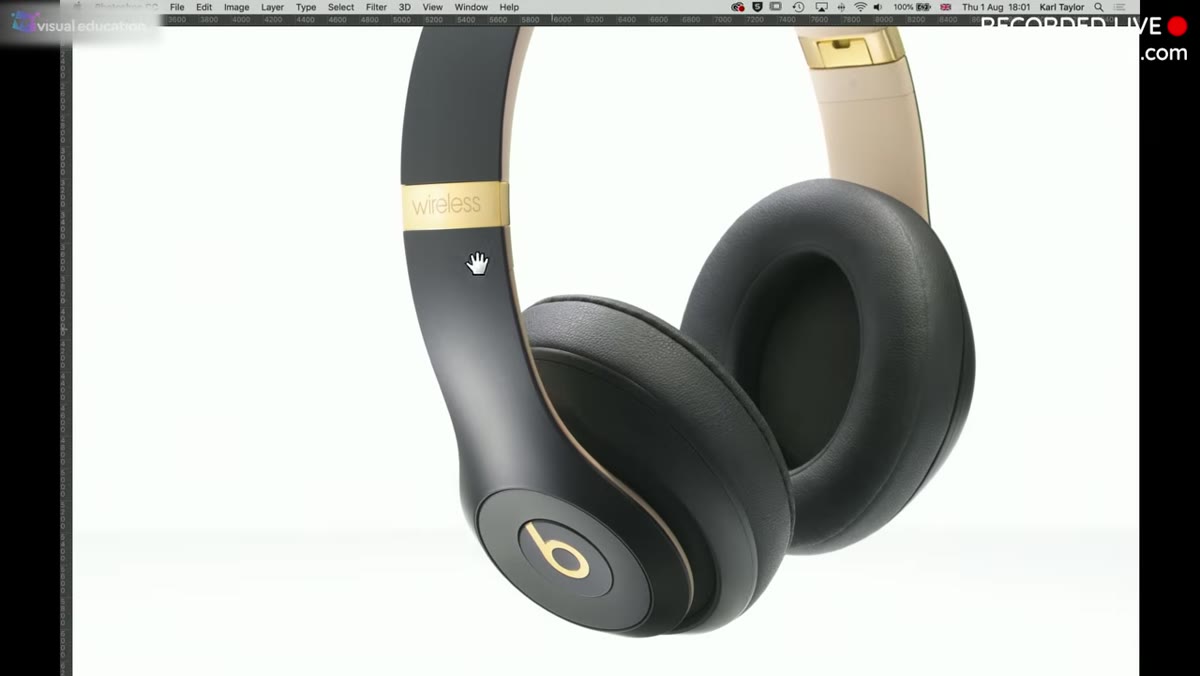 Kyle examining headphones, pointing to "wireless" text on ear cup
