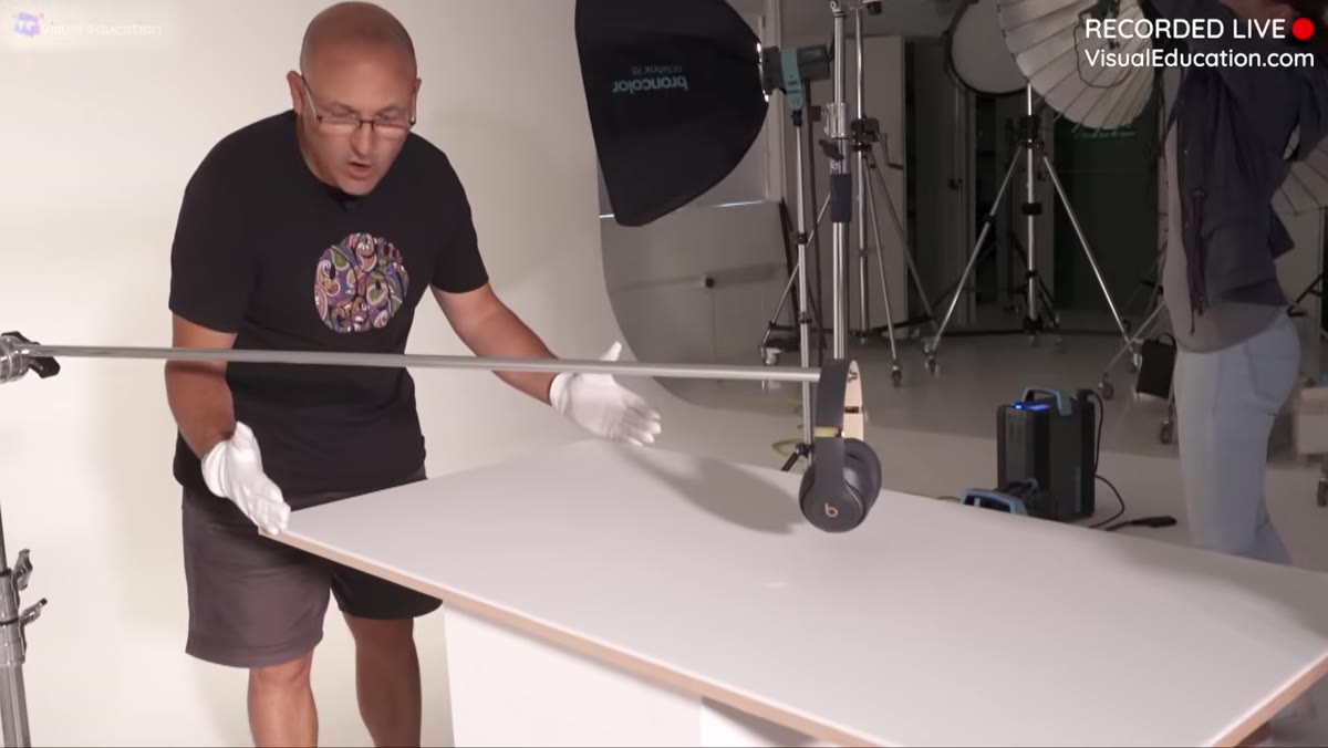 Wide shot showing narrow acrylic shooting surface with lights positioned close