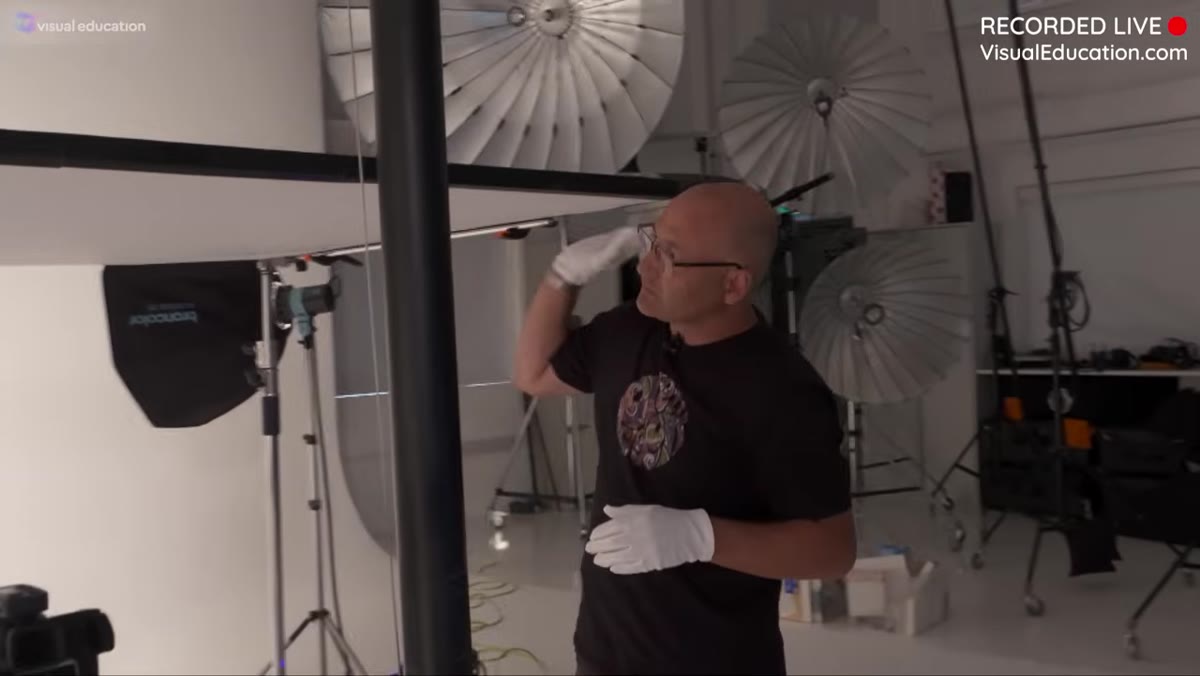Light on giraffe boom arm positioned over overhead scrim