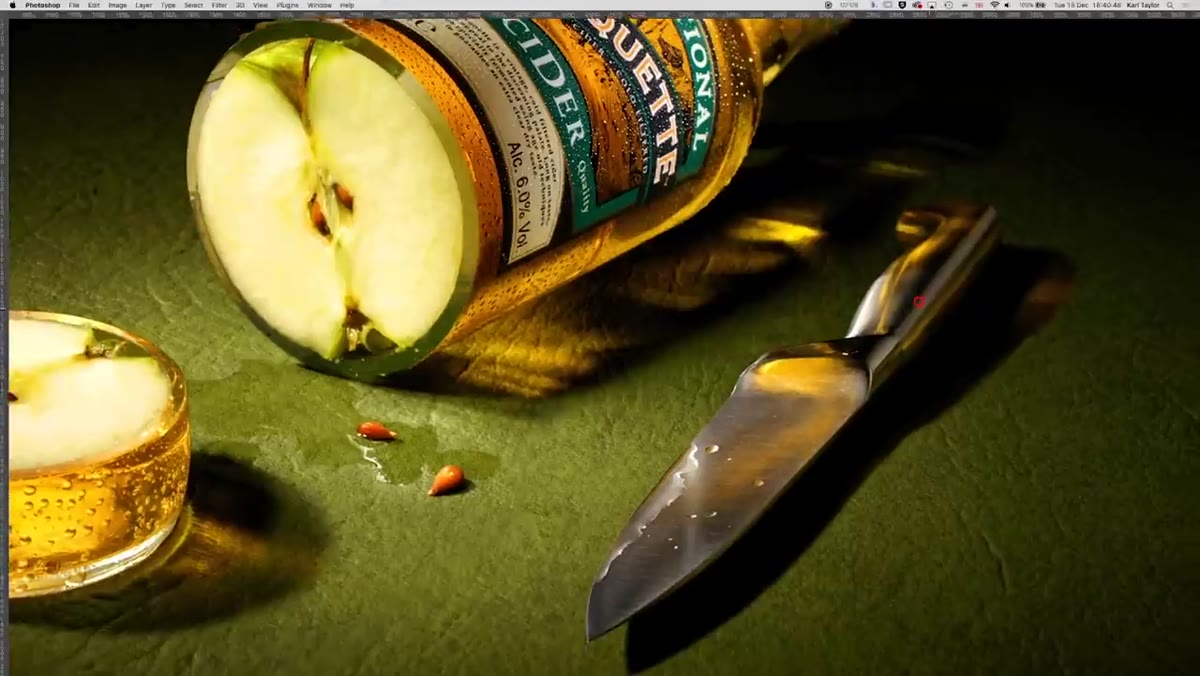 Knife on set with colored light refraction from bottle above