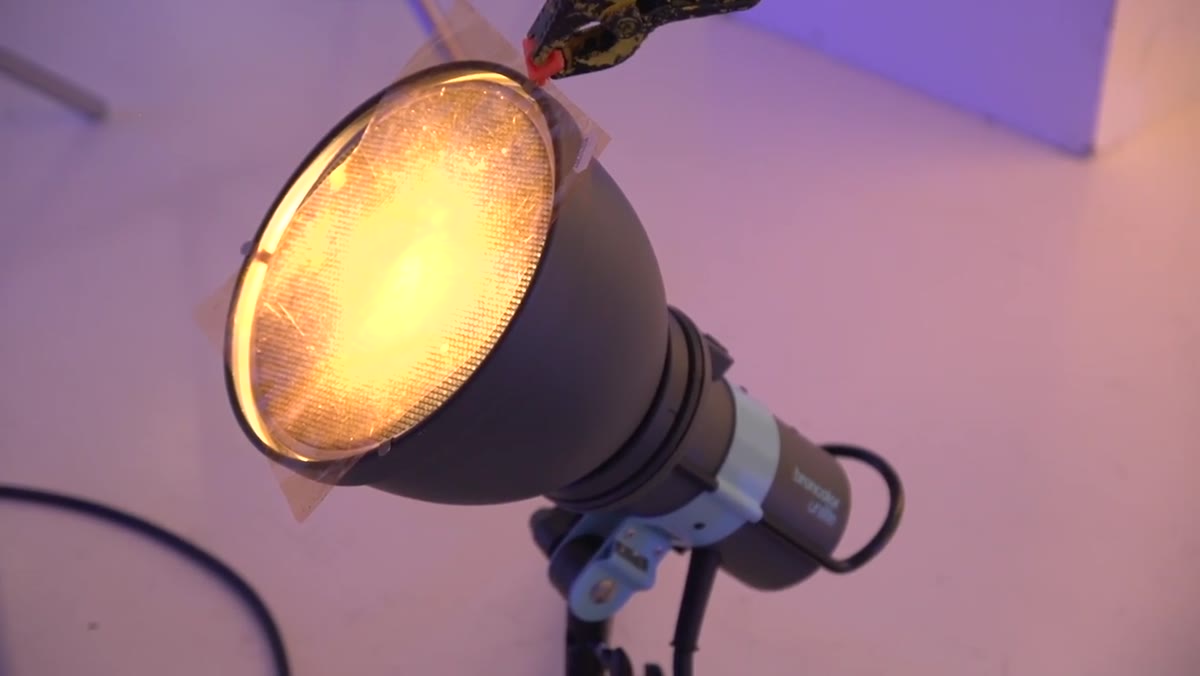 P-70 reflector with honeycomb grid casting warm glow behind bottle