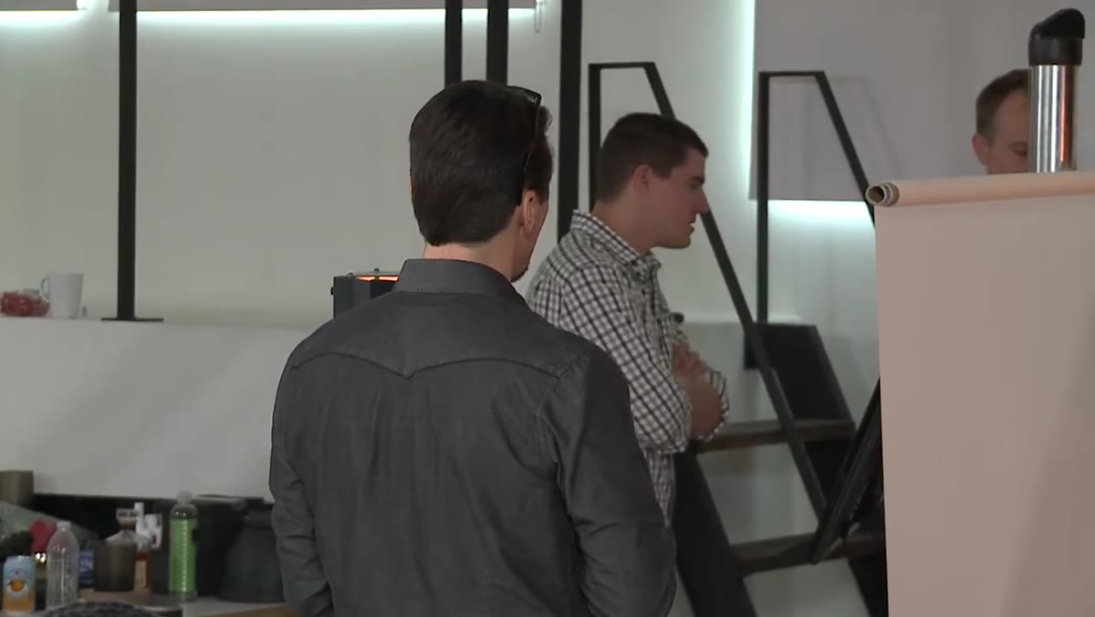 Team reviewing label readability on studio monitor versus secondary display