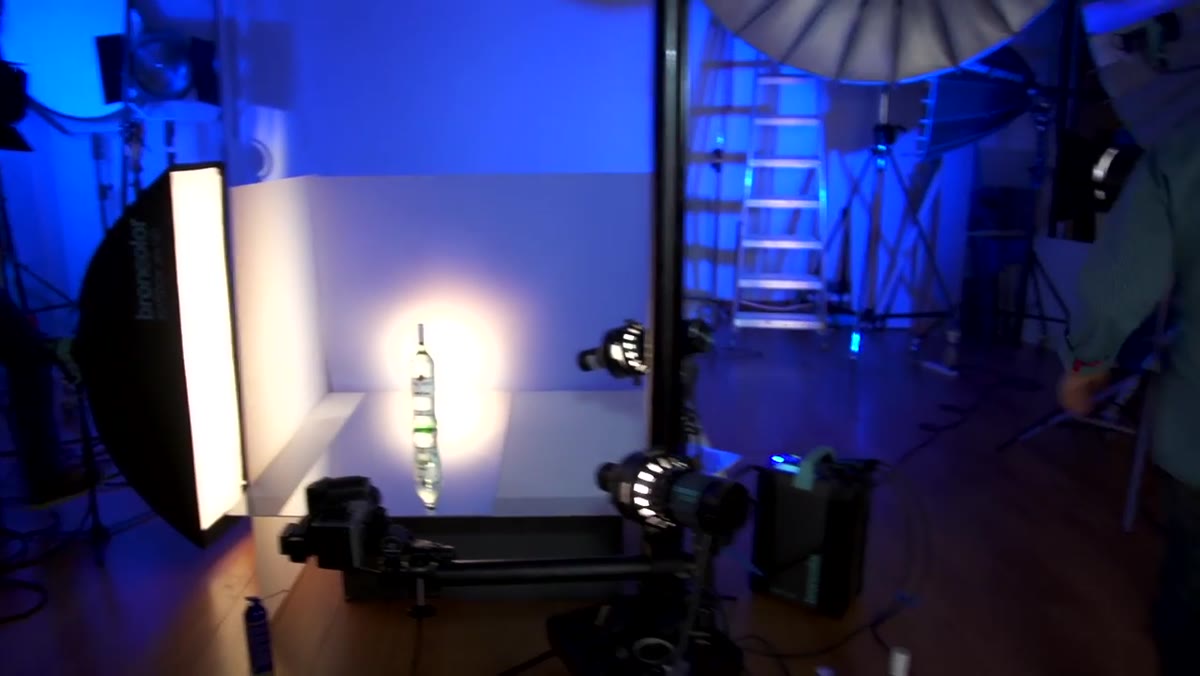 Light behind frosted perspex creating backlit glow through bottle