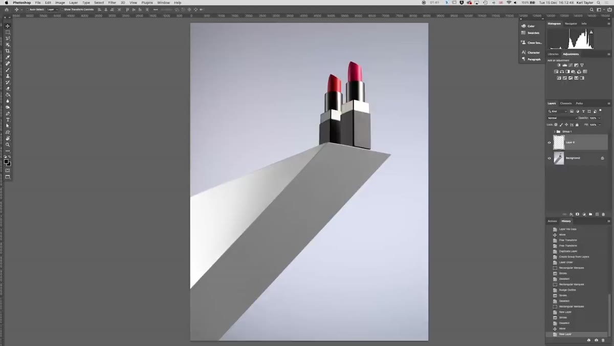 Camera positioned low, shooting upward toward elevated lipsticks