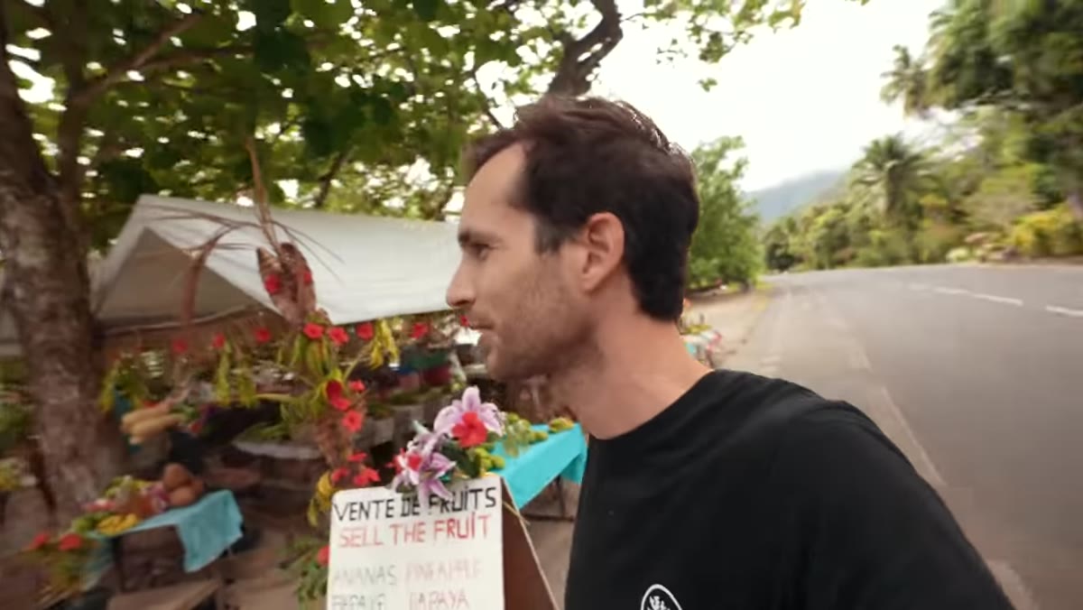 Pierre stops at a roadside fruit stand to shoot a local vendor
