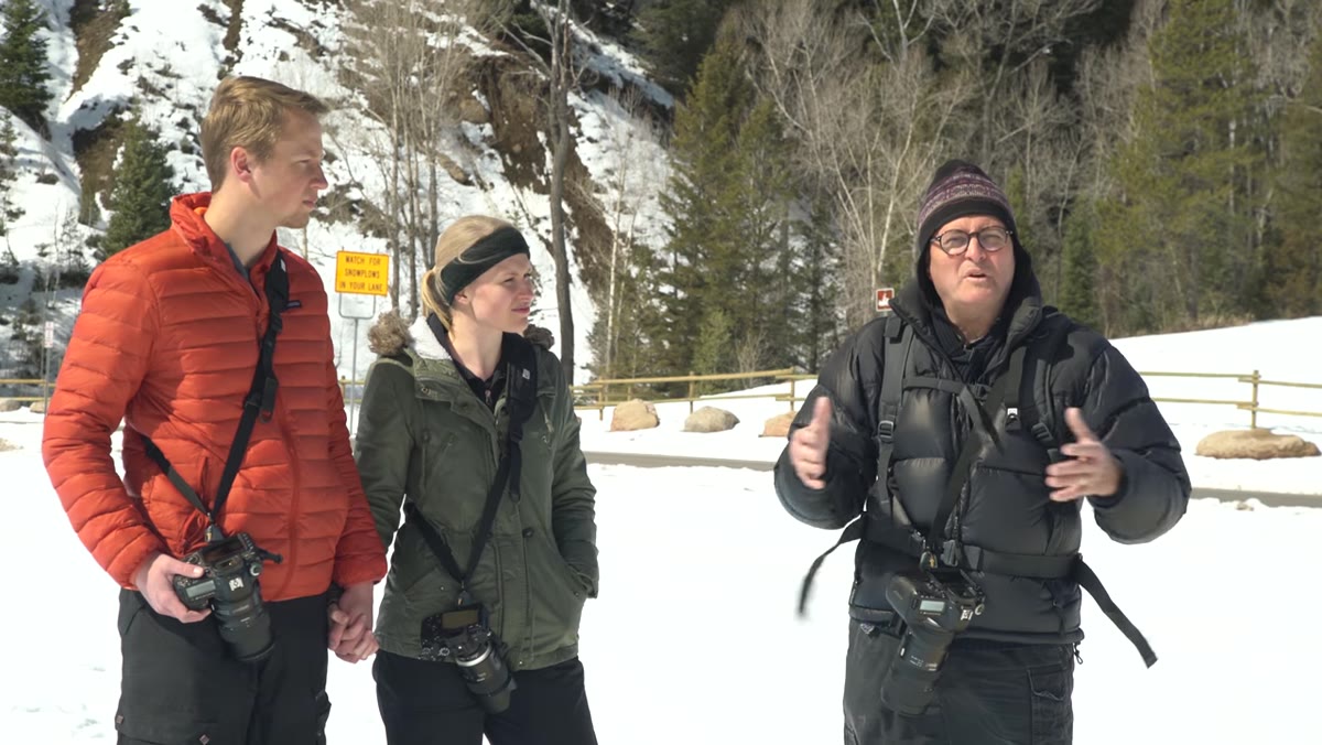 Jay gesturing toward the snowy mountain landscape as he discusses establishing shots