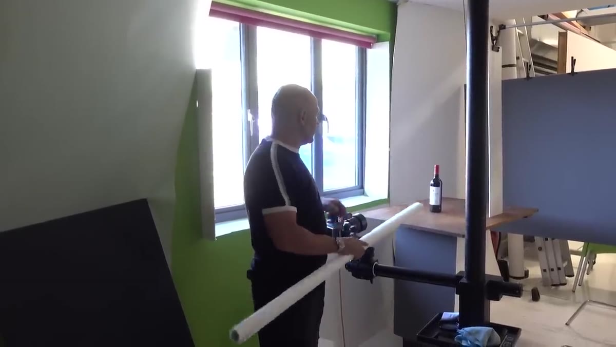 Wine bottle positioned on wooden base near window