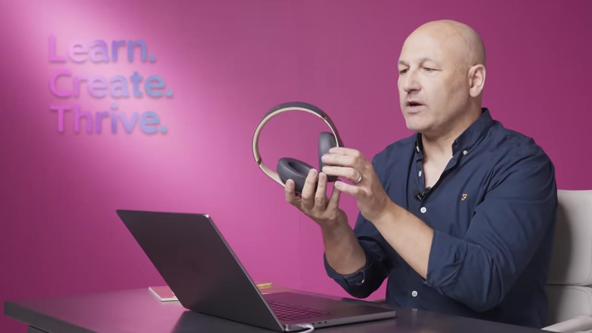 Headphones showing matte plastic alongside leather ear cushion detail