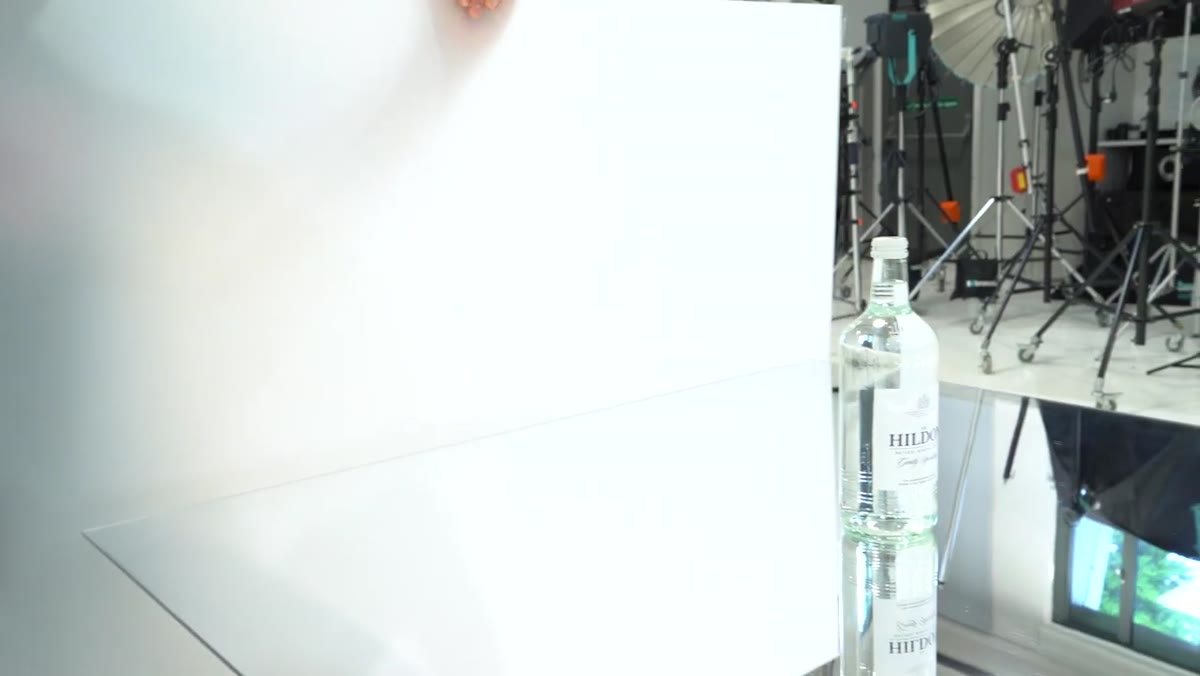 Frosted acrylic panel positioned behind the bottle