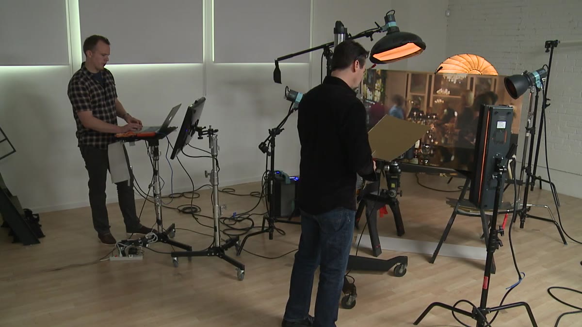 Photographer comparing color on a calibrated computer monitor