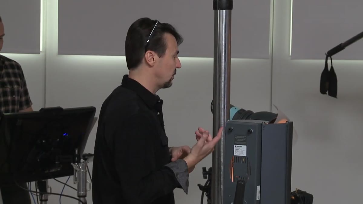 Photographer reviewing separate exposures for bottle base and neck label