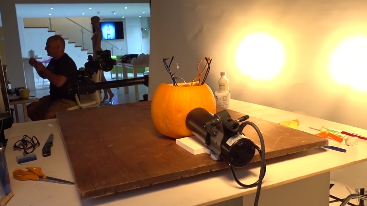 Two lights aimed at pumpkin through scrim roll diffusion panel