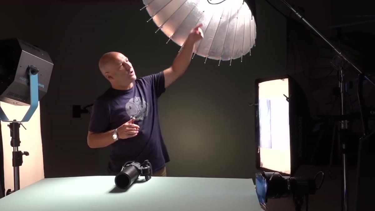 Overhead light casting downward pool of light and subject shadow