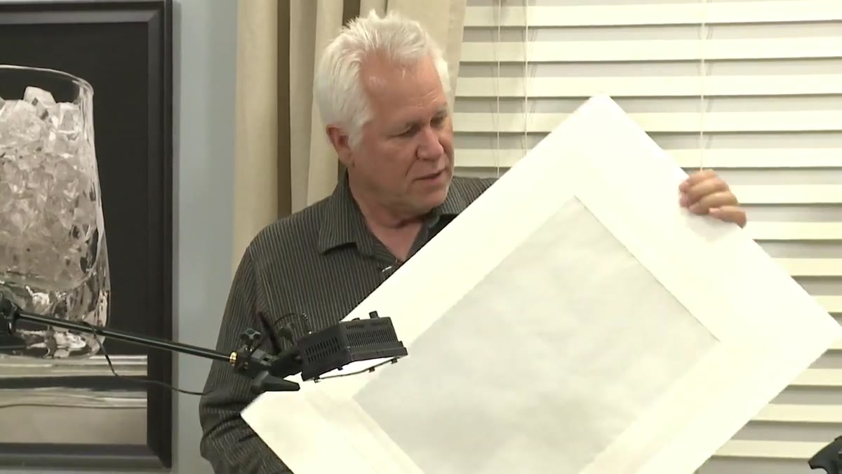 Foam core with parchment paper being held in front of the light source