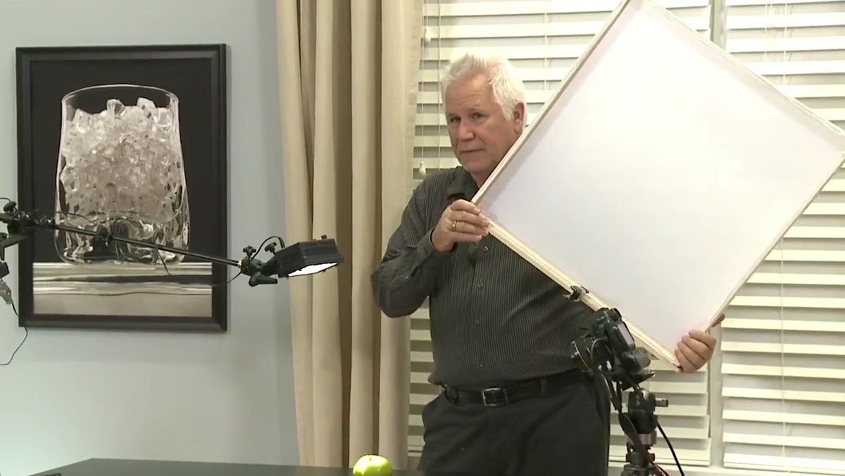 Wood-frame diffuser being brought over the subject from above